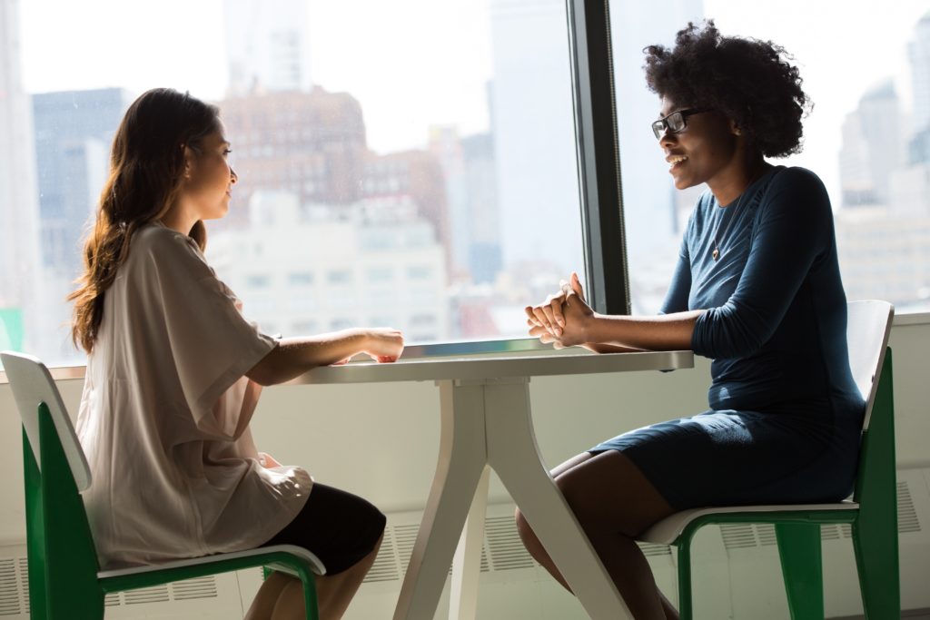 image of people sitting at desk for questions to ask when hiring an amazon marketing agency